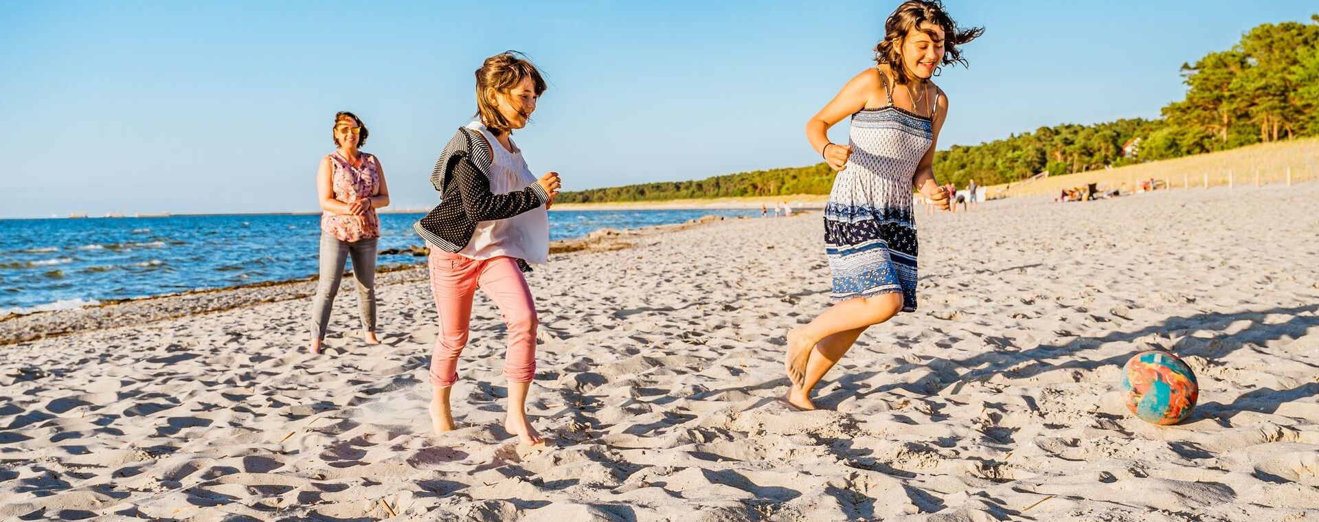 Children play with a ball on the beach