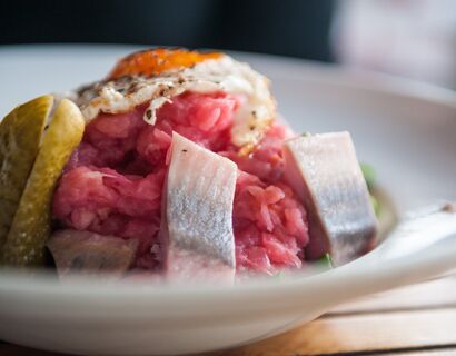 Close up of a court. Rosan risotto with spice cucumbers, fish swaps and fried egg